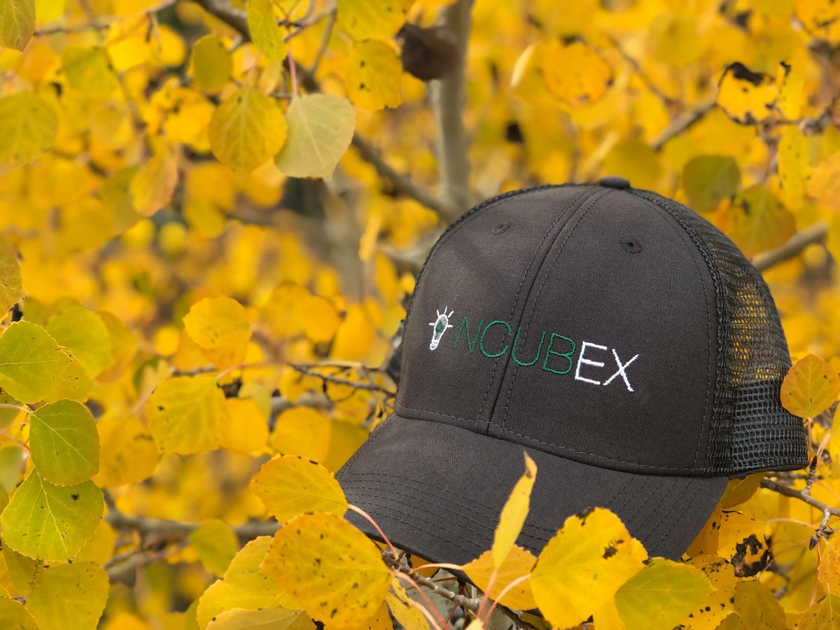 Black IncubEx hat with nature background
